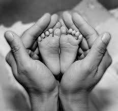 baby's feet in hands